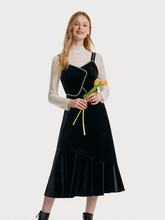 a lady in black spaghetti velvet dress with lace top